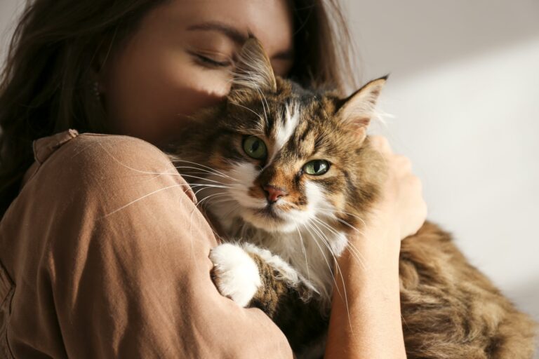 frau kuschelt innig mit ihrer katze